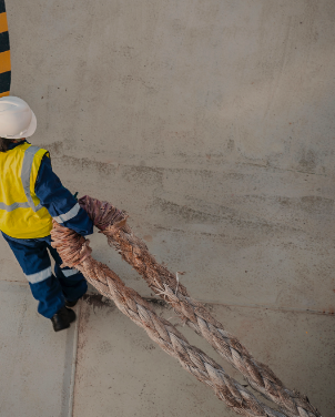 A Construction Worker Carrying A Heavy Rope - Personal Injury Attorney -Boxer & Gerson, LLP